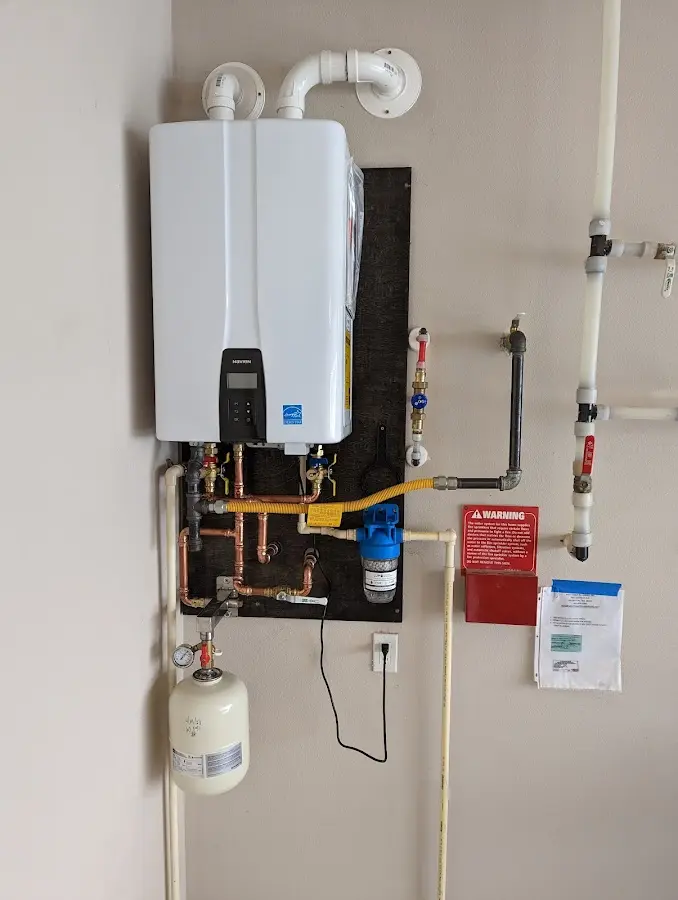 Professional plumber installing copper piping in a Sharpsburg home